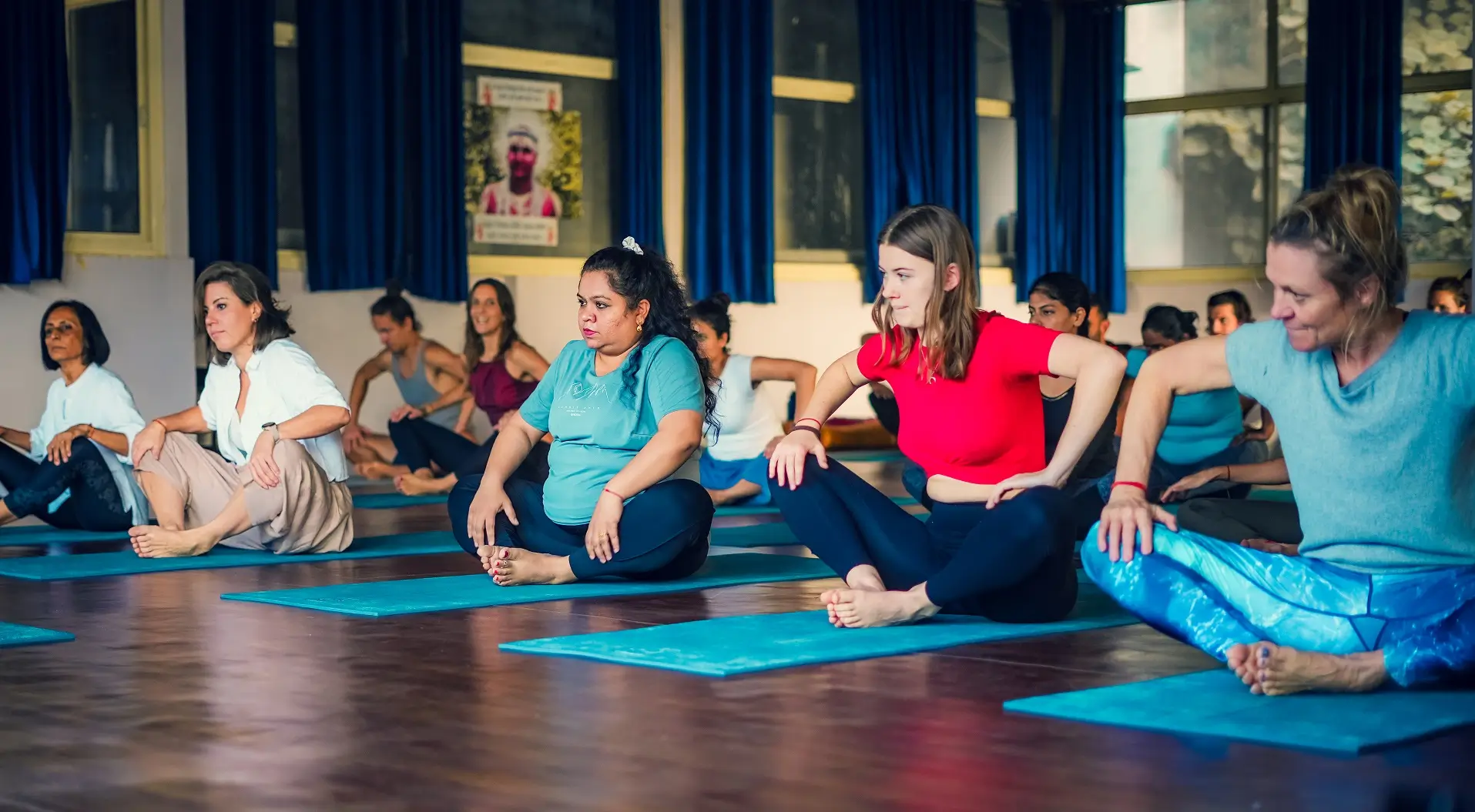 Trainees and their teacher together in the yoga shala after a class